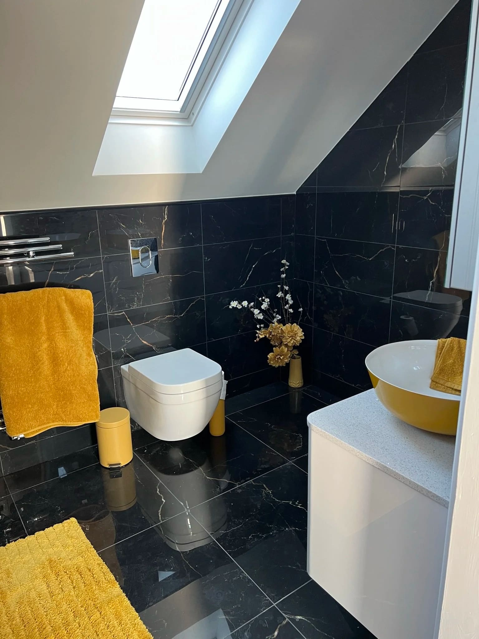 Bathroom with black marble tiles and skylight fitted in Grays