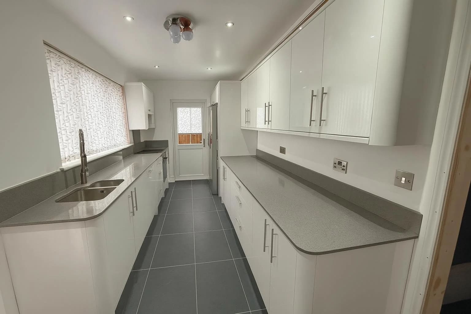 Fitted kitchen with white cabinets installed in Tilbury